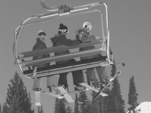 B A chairlift descends from a mountain top to pick up skiers at the bottom.