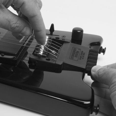 Re-Stringing Your Guitar 1: To remove strings, turn the tuning knob counter-clockwise until the string ball is fully visible and can be removed. Do not loosen beyond this point.