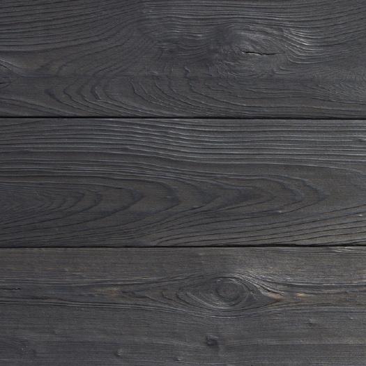 This charcoal layer is a sacrificial wear layer that will flake over time to reveal blackened cypress underneath with variations in color from grey to brown tones and over time more grey tones (see
