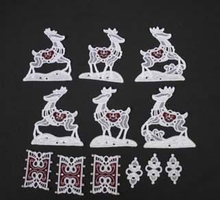 Insert the five buttonettes on one side of the rectangular appliqué connector into the five eyelets on the reindeer, from the inside of the reindeer