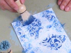 Squeeze out a pea-sized amount of a light blue watercolor onto a piece of scrap plastic or a paper plate.