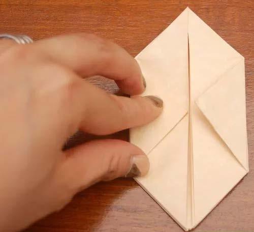 Fold in the two side pieces along the nondiagonal fold until you have a pyramid shape (Image 1). 4.