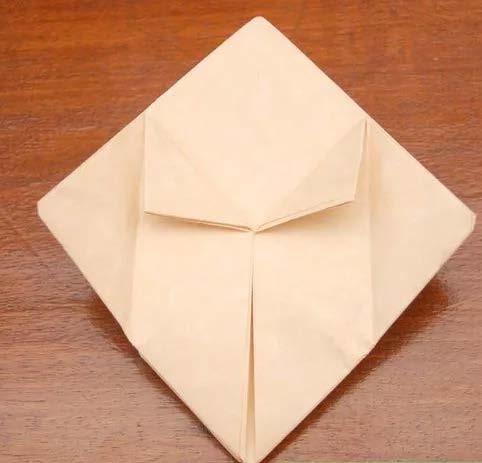 Fold the right and left corners to the center of the diamond shape. Repeat for the opposite side (Image 2). 6.