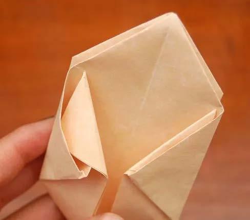 Unfold the larger triangles on the sides and fold down the smaller triangles one more fold (Image 3). 8.