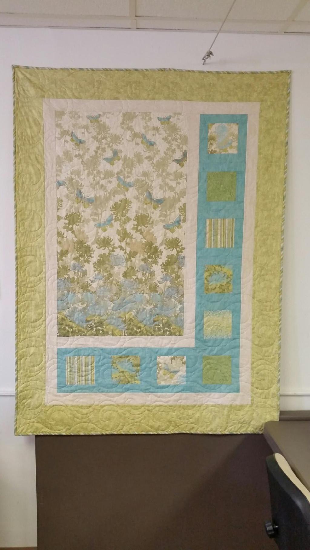 799. Sidelights - Sidelights uses a panel or large print too pretty to cut. Surround it on two sides with framed coordinating fabrics for a beautiful quilt.