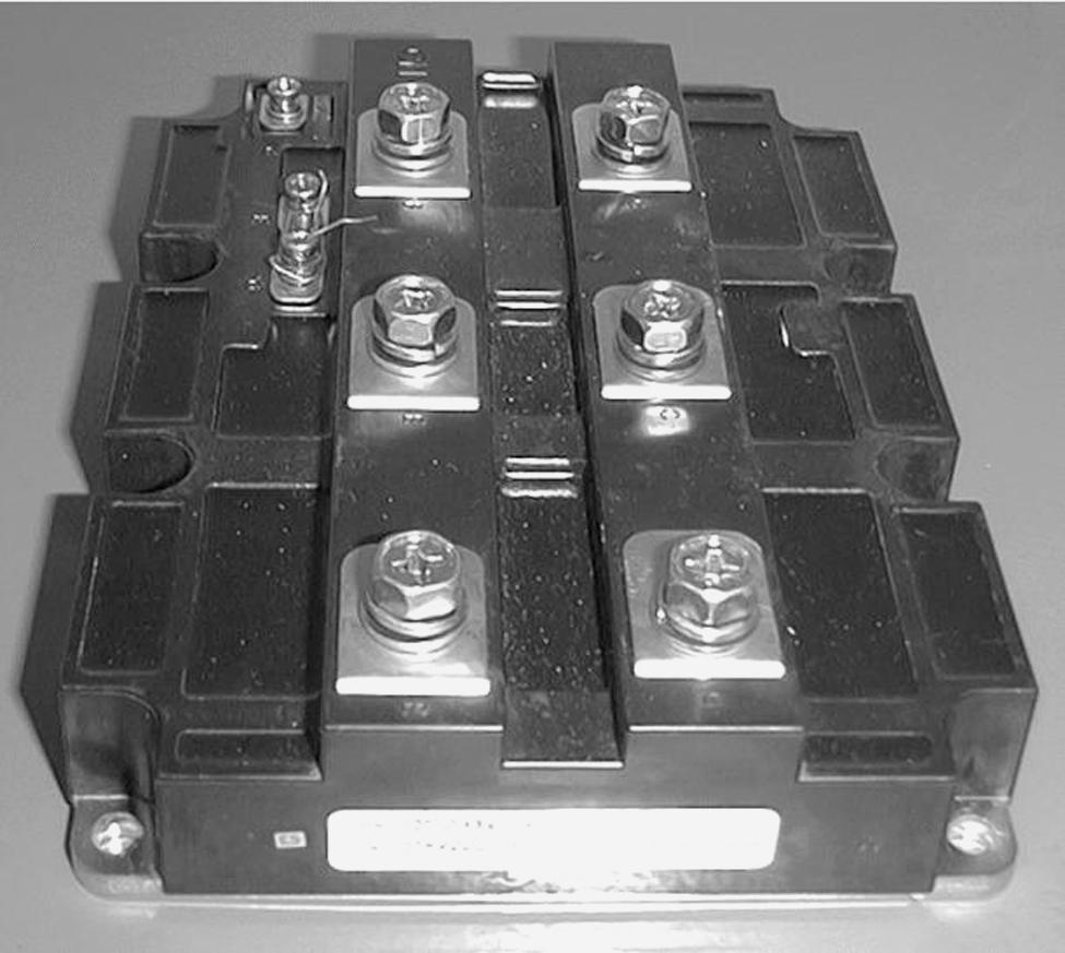 FIGURE 1.89 hotograph of a 1200-A, 3300-V IGBT module in which 24 1-cm 2 IGBT dies are paralleled together by wire bonds. The equivalent circuit for the IGBT, shown in Fig. 1.88b, consists of a wide-base pnp bipolar transistor driven by a short-channel MOSFET.