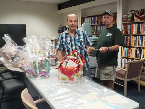 Friends Board preparing book baskets for the next fund-raising auction, and our January display case.