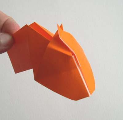 Start by making the head of the origami cow. Right before you fold the ears forward, stop.
