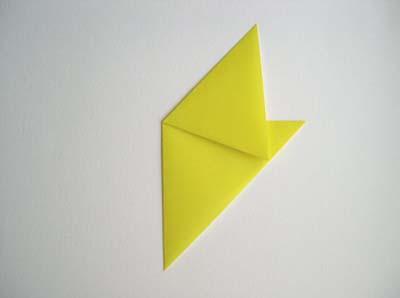 Then fold along the diagonal to give a triangle. Next fold the triangle in half to make a smaller triangle.