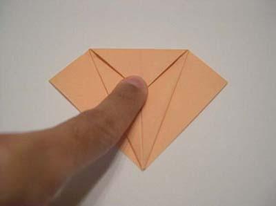 unfold. This is to create crease marks. Now begin the petal fold.