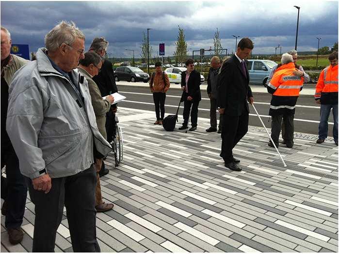 Passive transponders buried in the pavement and a dedicated electronic walking cane help to