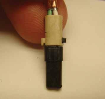 With the solder cup s opening facing you, solder the solid primary into the left contact and the striped primary into the