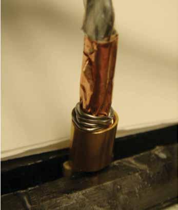 Wrap 0.015-inch solder around the inside of the ferrule (Figure 33); flow the solder (Figure 34).