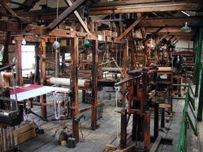 A view of the rows and rows of foot-powered jacquard looms.