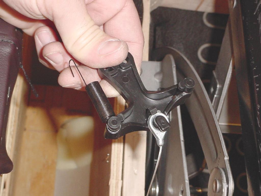 Remove the black nylon trip lever from the mechanism.