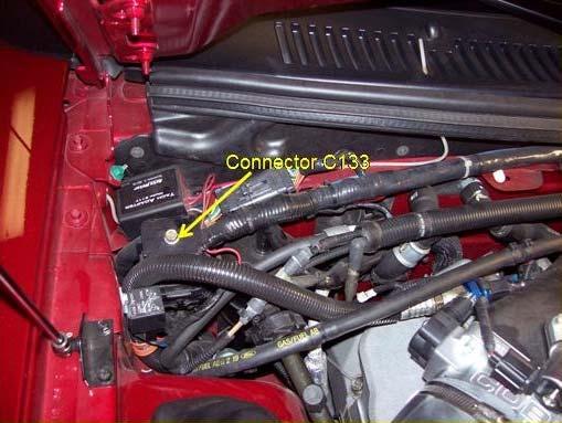 14) Locate the C133 connector in the passenger side rear of the engine compartment, unscrew the 10mm bolt, unplug it, and find the big RED wire at pin #34.