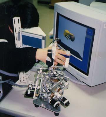 2 Desktop Force Display Our research into haptic interface started in 1986. The first step was the use of an exoskeleton.