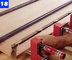 Because it's important to keep the finish from the top plywood surface, carefully apply masking tape around the perimeter of the plywood panel against the edging.