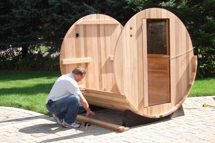 Now that you have the front and end pieces placed in the croze, begin alternately placing staves up the side of the sauna.