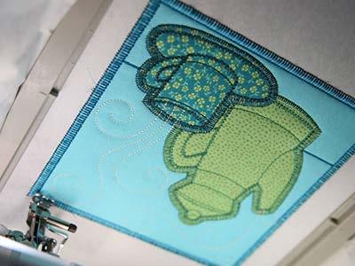 Place the hoop back on the machine and embroider the back piece tack down which includes