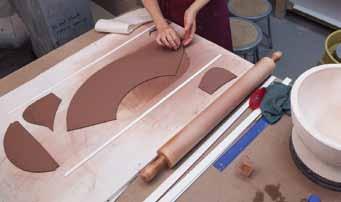 When joining two slabs she compresses the edge of the slab, beveling it with her finger in order to create more surface