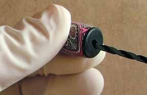 Remove the needle and insert it into the opposite end. Gently push the needle all the way through the snake. Rotate the needle to form a hole that is large enough to fit the rubber cord.