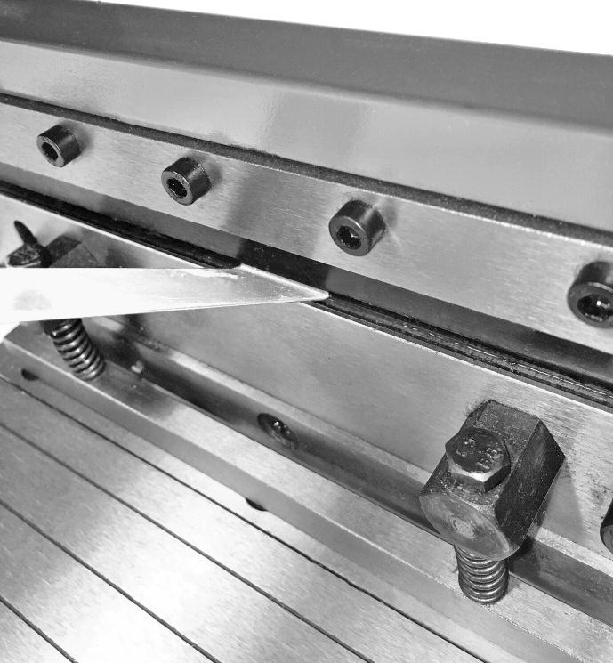 Note: The two spring-loaded bolts for the hold-down bar may interfere with the insertion of the workpieces, but will move out of the way during the bending operation.