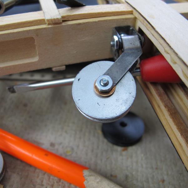 The top pulley should have the top of the eyelet facing the inspection window. The lower pulley should have the hex nut and eyelet flange face the bottom window.