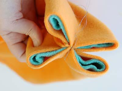 Bring the edges together there, and use a hand sewing need to sew a few tack stitches through all the layers of fabric.