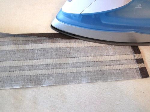 3. Fold each strip in half, aligning all the pressed edges. Pin in place. 4. Edgestitch in place around all four sides.