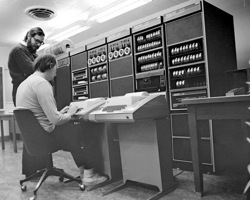 Dennis Ritchie (beard) with a PDP-11, circa ~1970s,