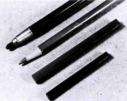 Looking from the lower right to the upper left, you see the small, rectangular Conte crayon; a larger, rectangular stick of hard pastel; hard pastel in the form of a pencil that's convenient for