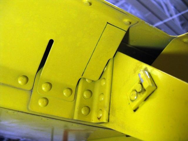 Step 5 (RV-3, 4, 7, 8, & 9): Remove the side cover from the inside of the fuselage, then disconnect the flap pushrod from the flap actuator weldment and allow the flap to swing