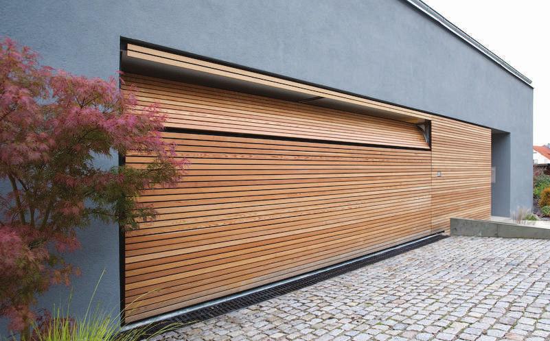 Flush garagedoor for two cars covered with wood of larch tree The facade-flush and flush-fitting doors from BeluTec allow