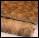 MINK CAFÉ THROW Mink in full hides. Back in wool, angora and cashmere. This fur is composed of European minks. Indulge in the sumptuous feel of fur with our luxury real fur collection.