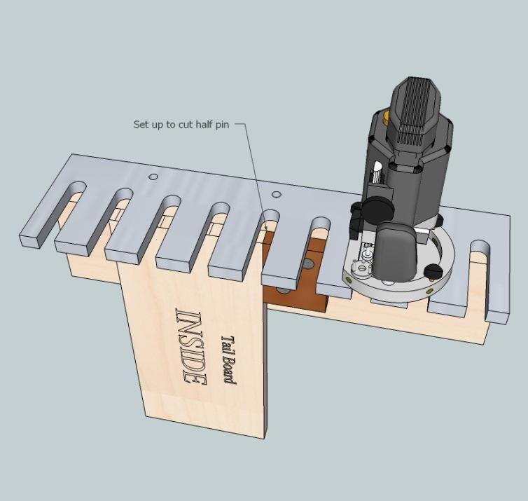 The tail board can be placed in a bench vice with either side facing out. It does not matter for the tail board. The edge of a jig finger is placed along the pencil line for one of the half-pins.