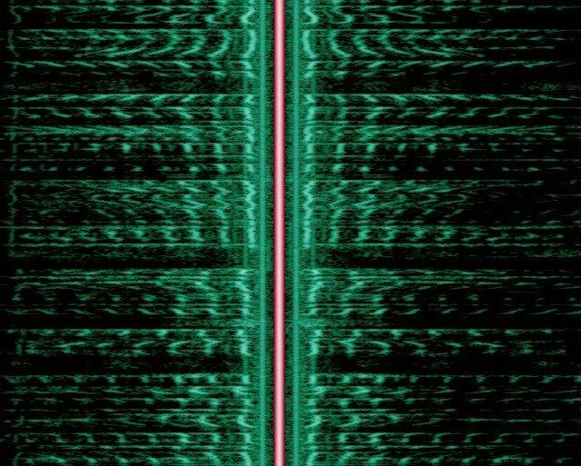 Fig 3: The spectrogram of an AM broadcast shows its two sidebands (green) separated by the carrier signal (red).
