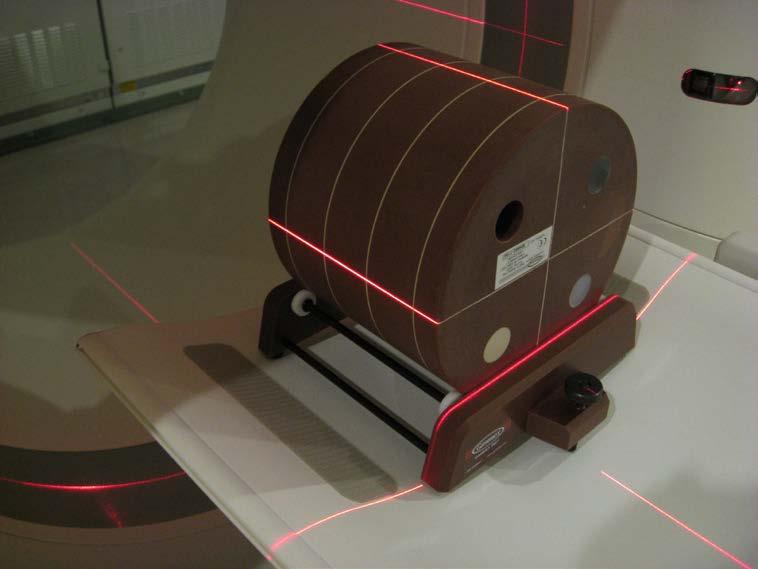 The phantom oriented with the orthogonal lasers, ready for scanning The phantom is aligned in all three planes using the motorized table movements and the screw knob seen at the front of this image.