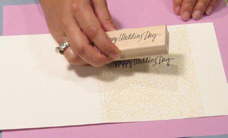 Ink the Happy Wedding Day stamp and stamp the image on the front of the card, 1" from the fold