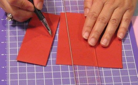 Use a pen knife and a ruler to cut 1 " off of the left end of the envelope. Notch the envelope.
