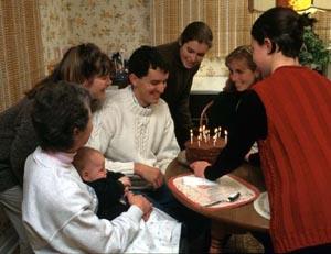 We could probably all agree fairly quickly that this photograph shows a birthday party for the man in the white sweater, that the other people in the photo are his family, that it is taken in his