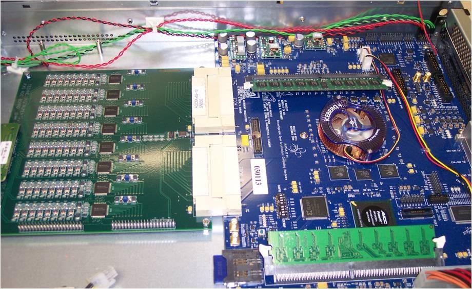 Figure 6.1: Interior view of the 64-input x64adc (left) connected to a CASPER ROACH FPGA board (right).the x64adc uses 8 ADC chips, each sampling 8 independent signals for 64 total.