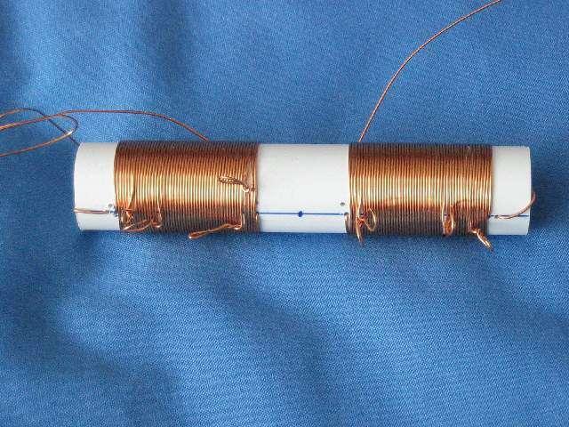 Then using 0.6mm enamelled copper wire feed the end through the outer holes and wind coils with taps at 7 turns and again at 16 turns. Then continue winding until you get to the second hole.