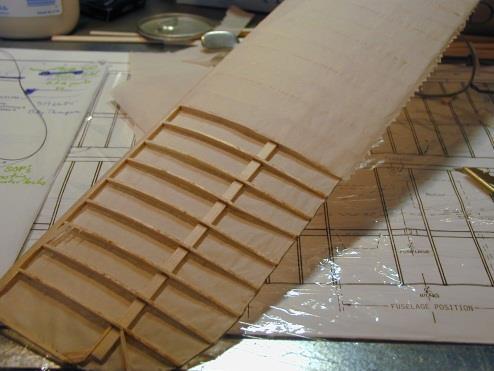 The wing can now be sanded lightly to remove glue pieces and fuzz and for shaping of the leading edge of the wing.