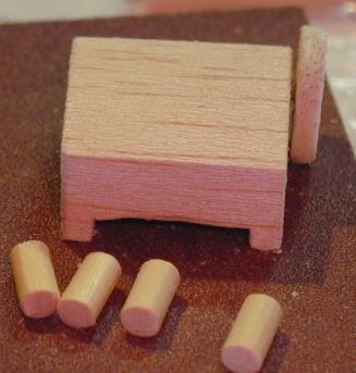 Fold a piece of fine sand paper between your fingers, place a piece of 1/16 square balsa within it and rotate to make it round.