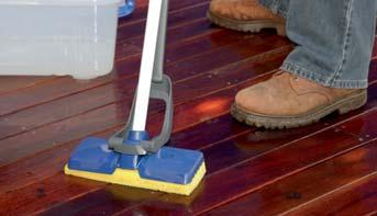 STEP 4 Using a stiff bristled brush, scrub the solution into the timber fi bres of decking