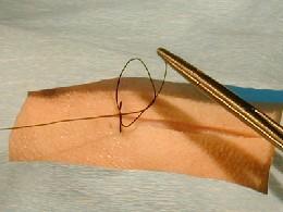 The needle holder is then rotated toward the surgeon to