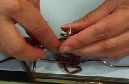 Place this knot under the clip end of the clipboard to hold in place.