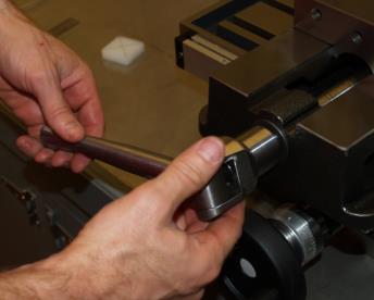 Make sure the workpiece is securely clamped in the vise before beginning work.