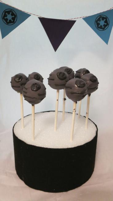 DEATH STAR CAKE POPS MATERIALS NEEDED: Baked cake (your favorite box mix) 1 can of frosting (your favorite flavor) Candy coating in black and white Lollipop sticks Parchment lined baking sheet Small
